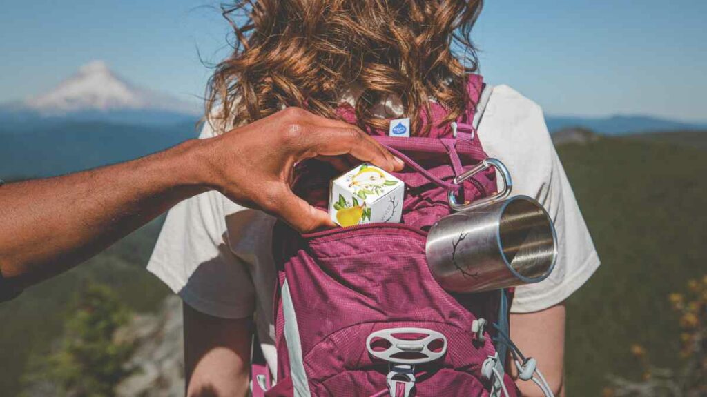 Pear Wyld Gummies in a hiker’s backpack. CBG Gummies may provide anti-anxiety effects.