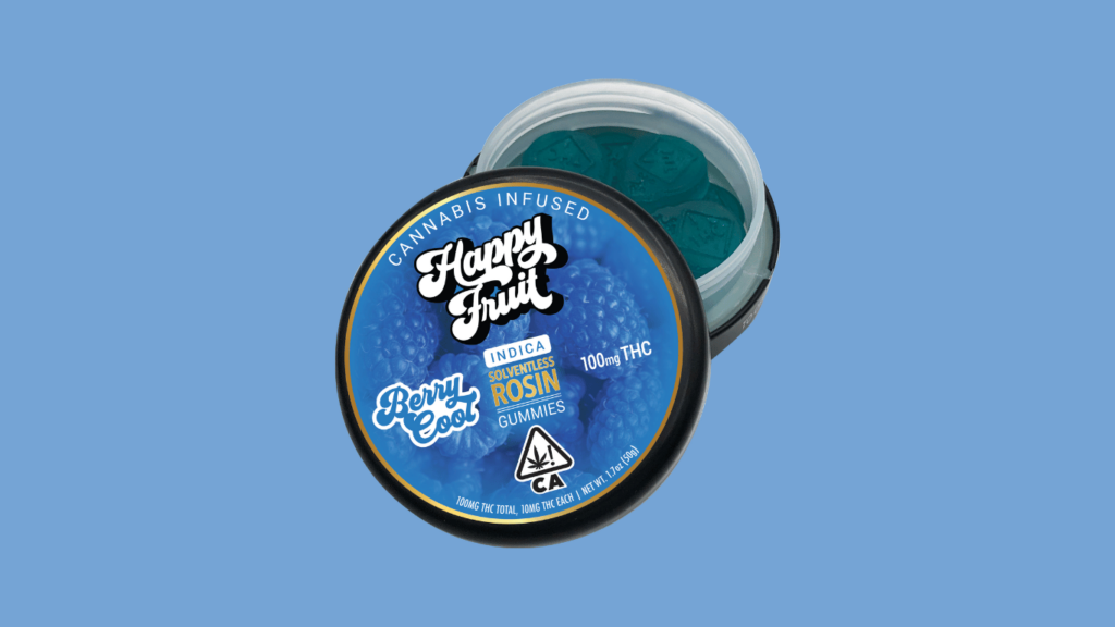 An image of an open container of indica happy fruit delta 9 live rosin gummies against a blue background. The gummies inside the container are visible and are blue raspberry flavored. Product image by Happy Fruit.